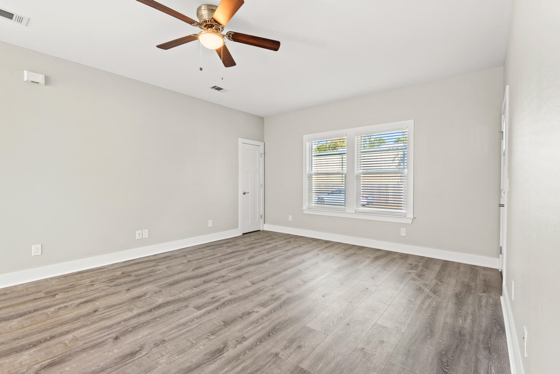 46 Winfield Street Niceville, FL 32578 - Photo 6 of 32 wooden floor in an empty room with a window