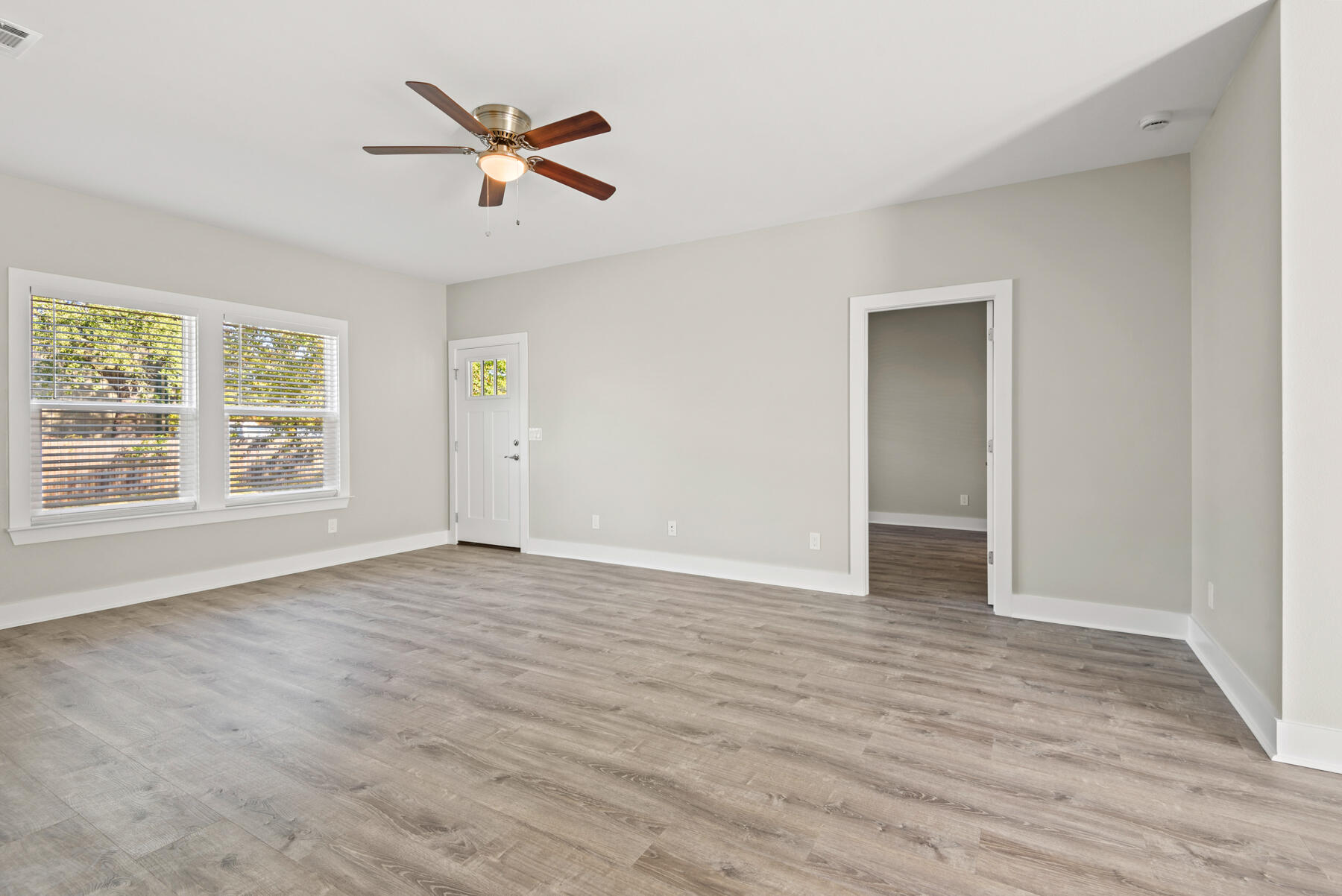 46 Winfield Street Niceville, FL 32578 - Photo 7 of 32 a view of an empty room with wooden floor and a window
