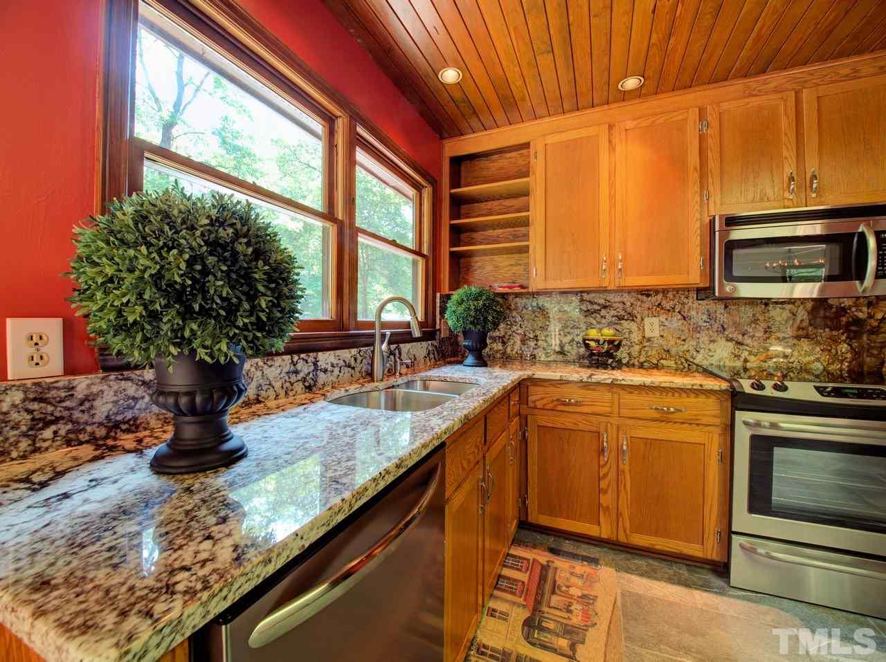 8316 Heel Stone Court Raleigh, NC 27613 - Photo 12 of 25 a kitchen with stainless steel appliances granite countertop a sink a stove and a microwave
