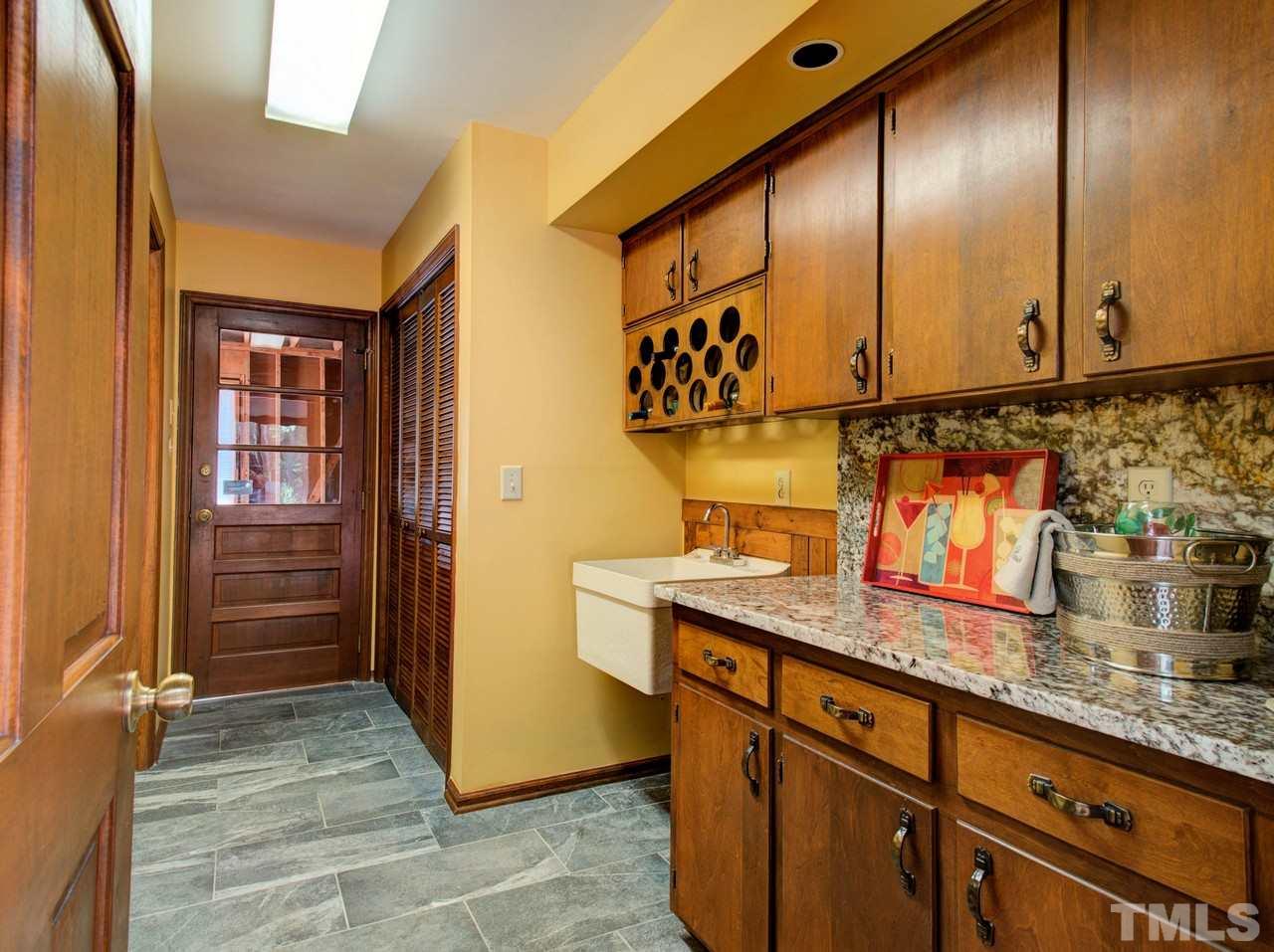 8316 Heel Stone Court Raleigh, NC 27613 - Photo 15 of 25 a kitchen with granite countertop stainless steel appliances a counter space and cabinets