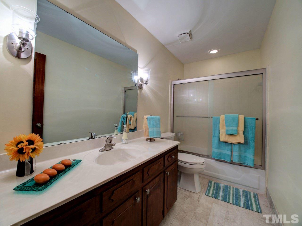 8316 Heel Stone Court Raleigh, NC 27613 - Photo 17 of 25 a bathroom with a sink double vanity and a mirror