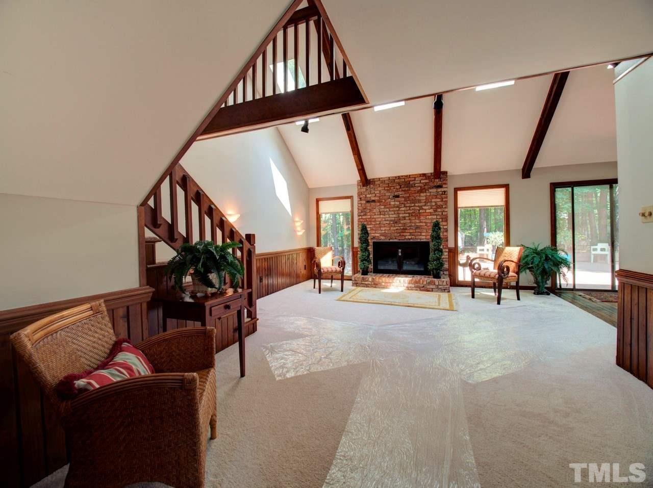 8316 Heel Stone Court Raleigh, NC 27613 - Photo 3 of 25 a living room with furniture and a fireplace