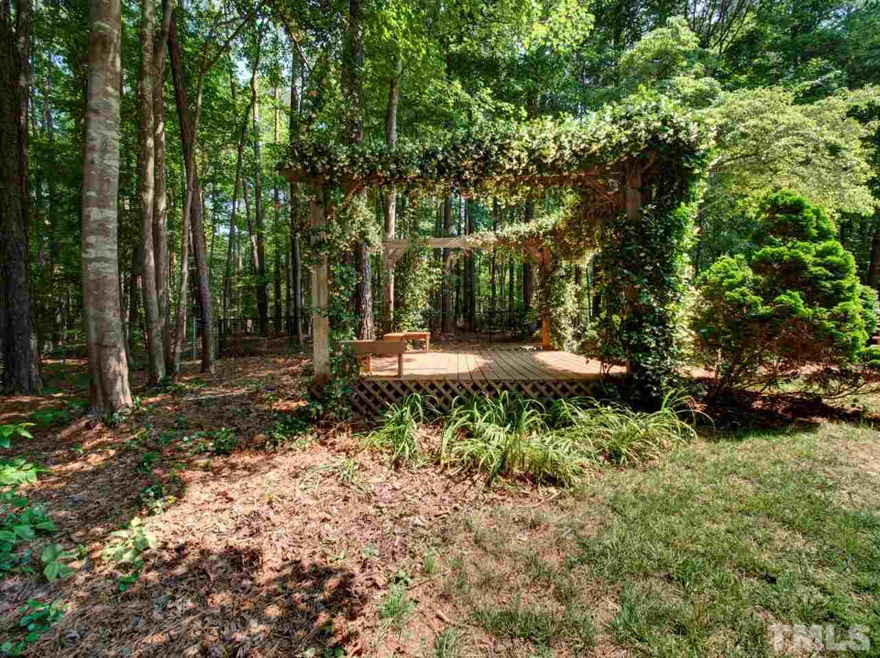 8316 Heel Stone Court Raleigh, NC 27613 - Photo 24 of 25 a backyard of a house with lots of green space