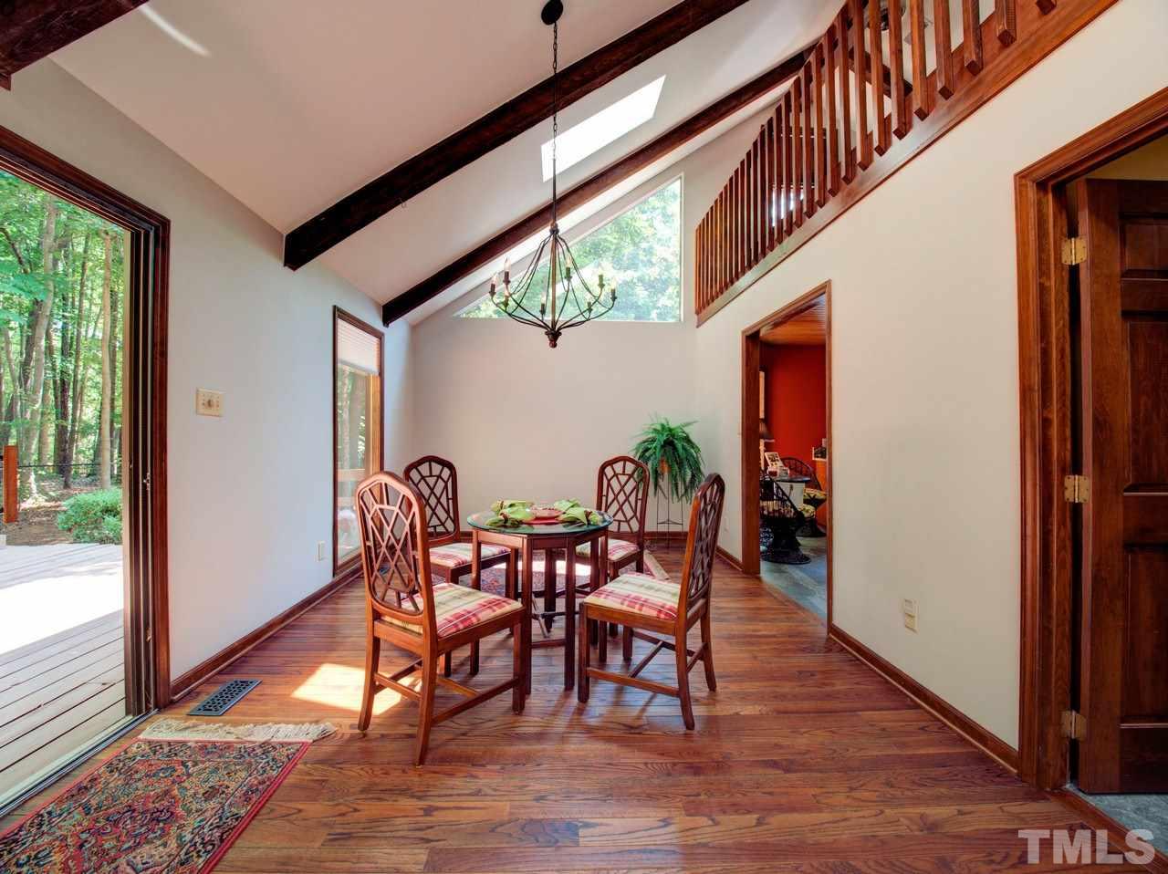 8316 Heel Stone Court Raleigh, NC 27613 - Photo 5 of 25 a dining room with furniture a rug and wooden floor