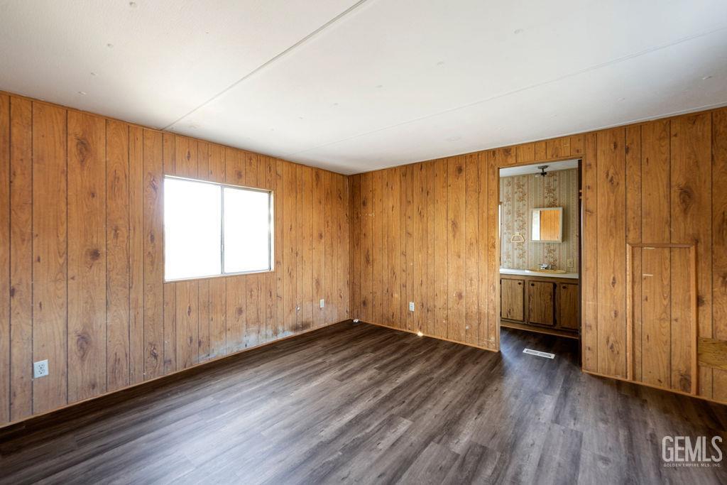 Undisclosed Address Bakersfield, CA 93313 - Photo 11 of 15 an empty room with wooden floor and windows