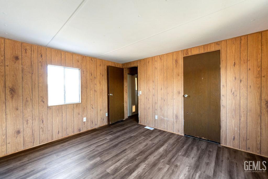 Undisclosed Address Bakersfield, CA 93313 - Photo 12 of 15 a view of an empty room with wooden floor and a window