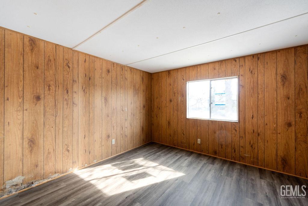 Undisclosed Address Bakersfield, CA 93313 - Photo 4 of 15 a view of an empty room with wooden floor and a window