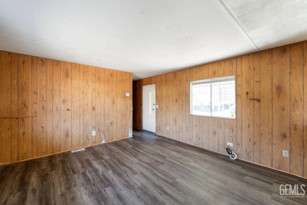Undisclosed Address Bakersfield, CA 93313 - Photo 7 of 15 an empty room with wooden floor and windows