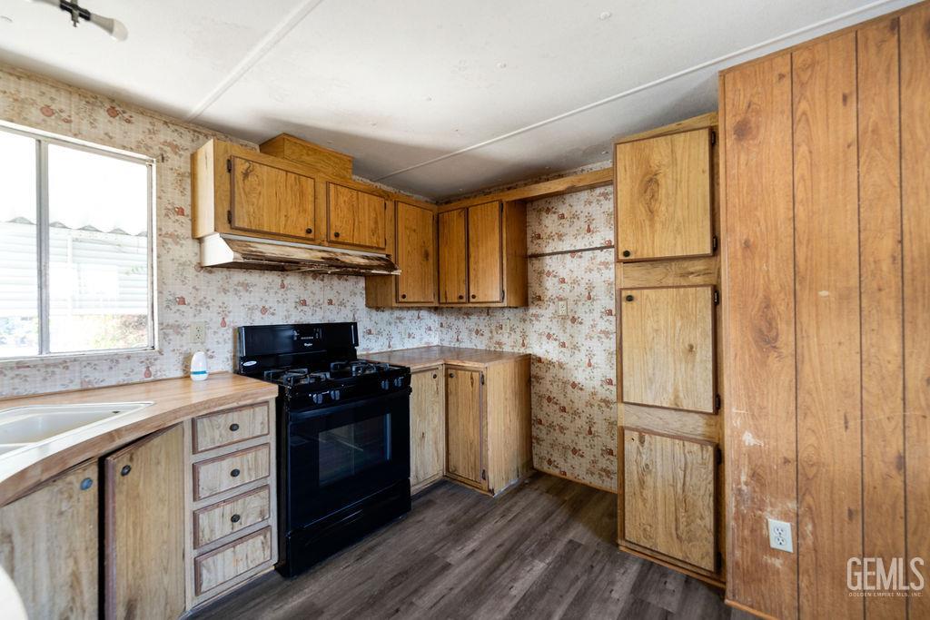 Undisclosed Address Bakersfield, CA 93313 - Photo 9 of 15 a kitchen with a stove a sink and a refrigerator