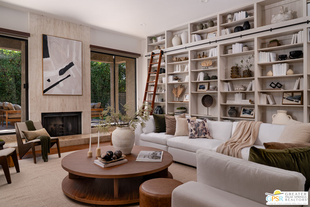a living room with furniture and a fireplace