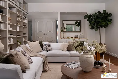 a living room with furniture and a potted plant
