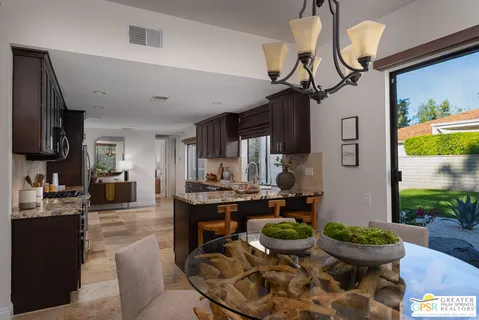 a kitchen with a stove and a dining table