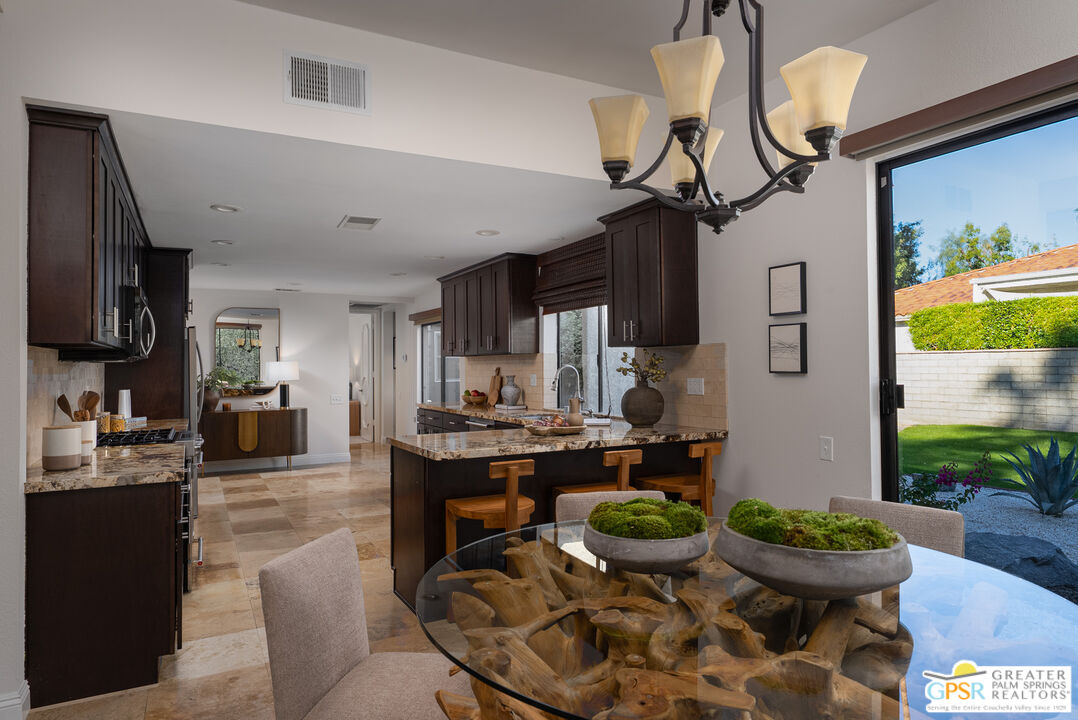15 Estrella Street Rancho Mirage, CA 92270 - Photo 17 of 37 a kitchen with a stove and a dining table
