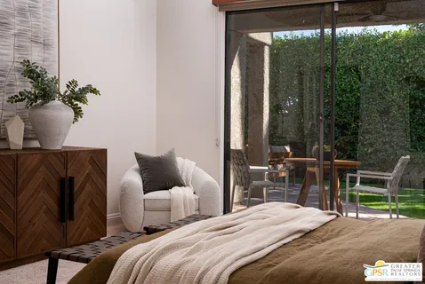 a bedroom with a bed and a potted plant