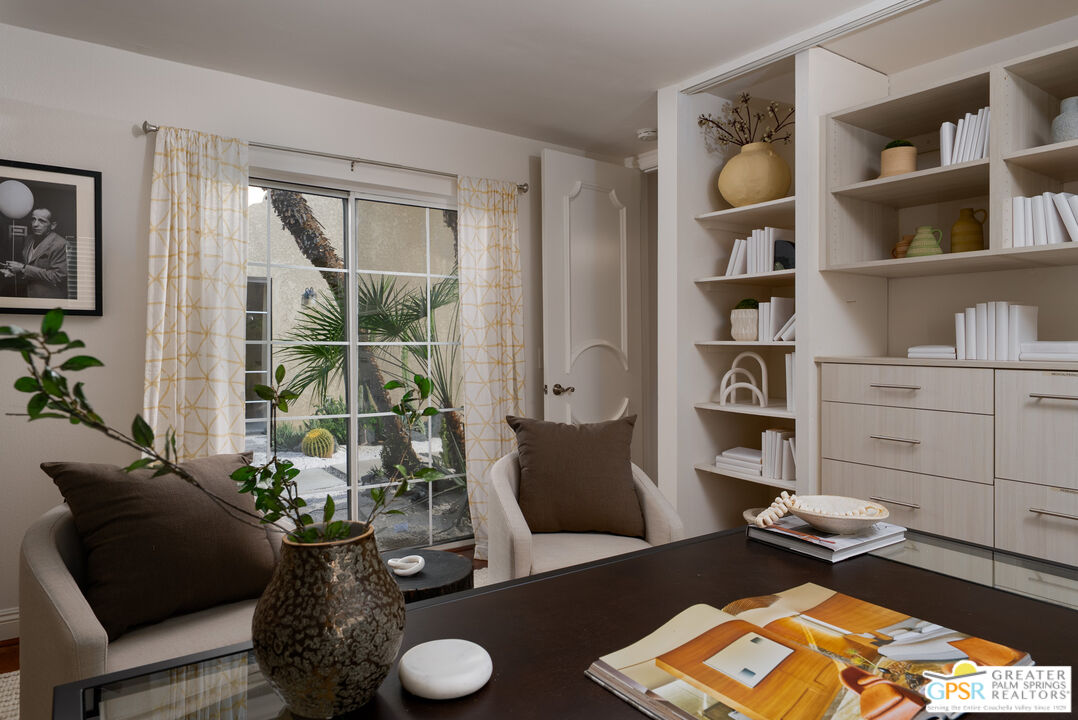 15 Estrella Street Rancho Mirage, CA 92270 - Photo 28 of 37 a living room with furniture and a book shelf