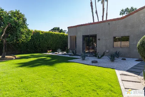 a view of swimming pool with outdoor seating and plants