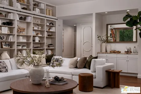 a living room with furniture and a book shelf
