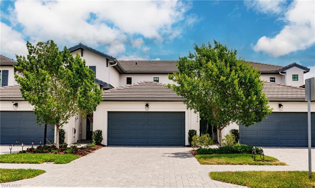 7536 Carnegie Way Naples, FL 34119 - Photo 1 of 23 a front view of a house with a yard and garage