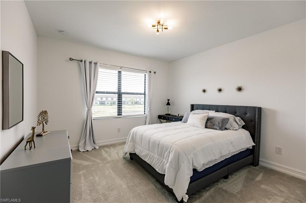 7536 Carnegie Way Naples, FL 34119 - Photo 19 of 23 a bedroom with double bed and a window