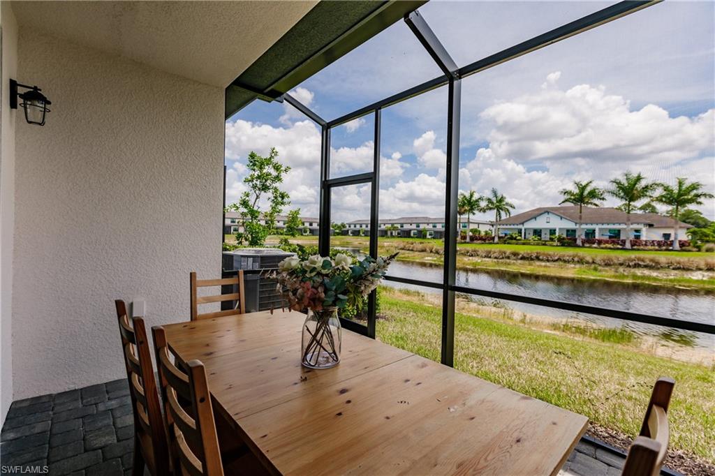 7536 Carnegie Way Naples, FL 34119 - Photo 22 of 23 a view of a swimming pool with a table and chairs