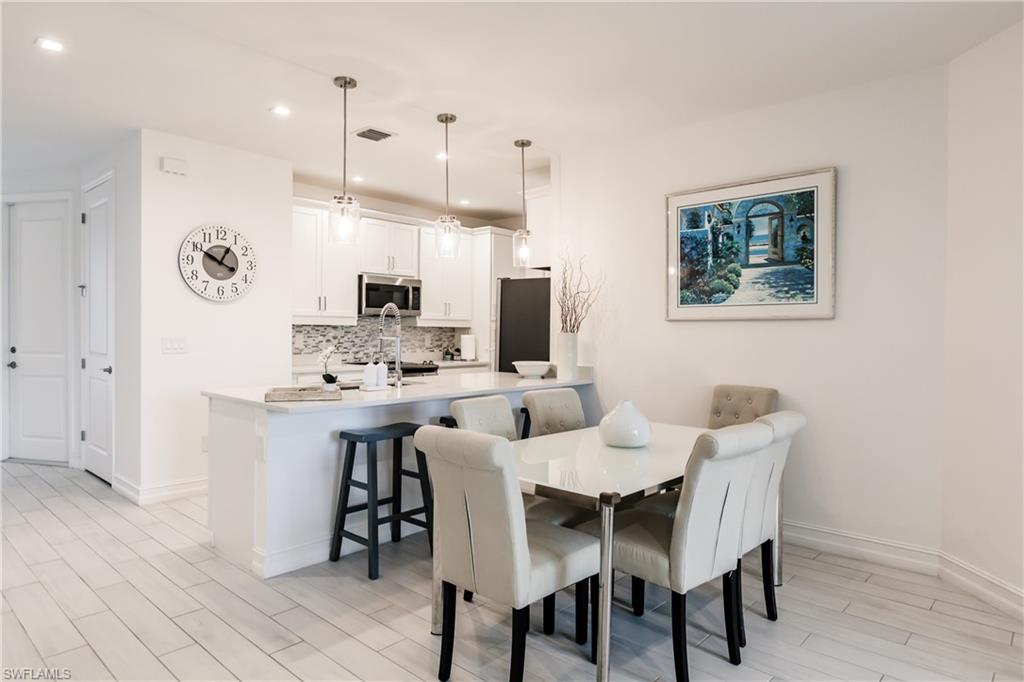 7536 Carnegie Way Naples, FL 34119 - Photo 5 of 23 a view of a dining room with furniture