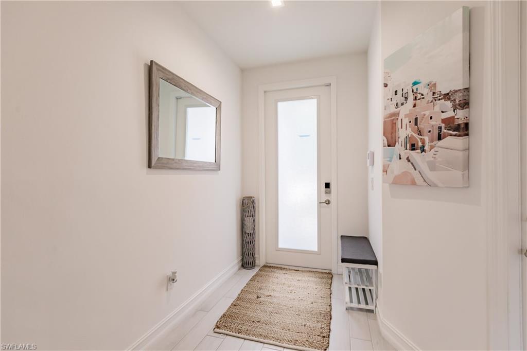 7536 Carnegie Way Naples, FL 34119 - Photo 7 of 23 wooden floor with white walls