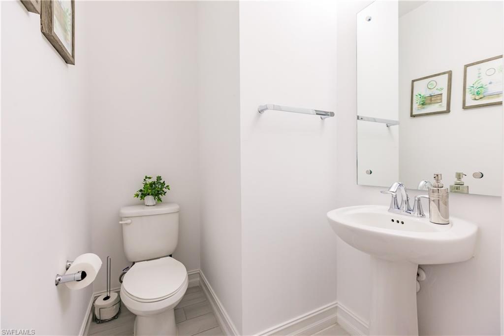 7536 Carnegie Way Naples, FL 34119 - Photo 8 of 23 a bathroom with a sink toilet and a mirror