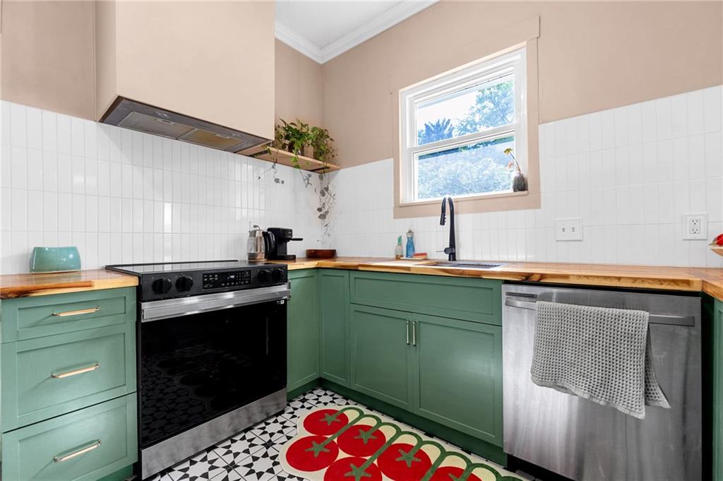 1608 Carroll Drive Northwest Atlanta, GA 30318 - Photo 14 of 43 a kitchen with cabinets and window