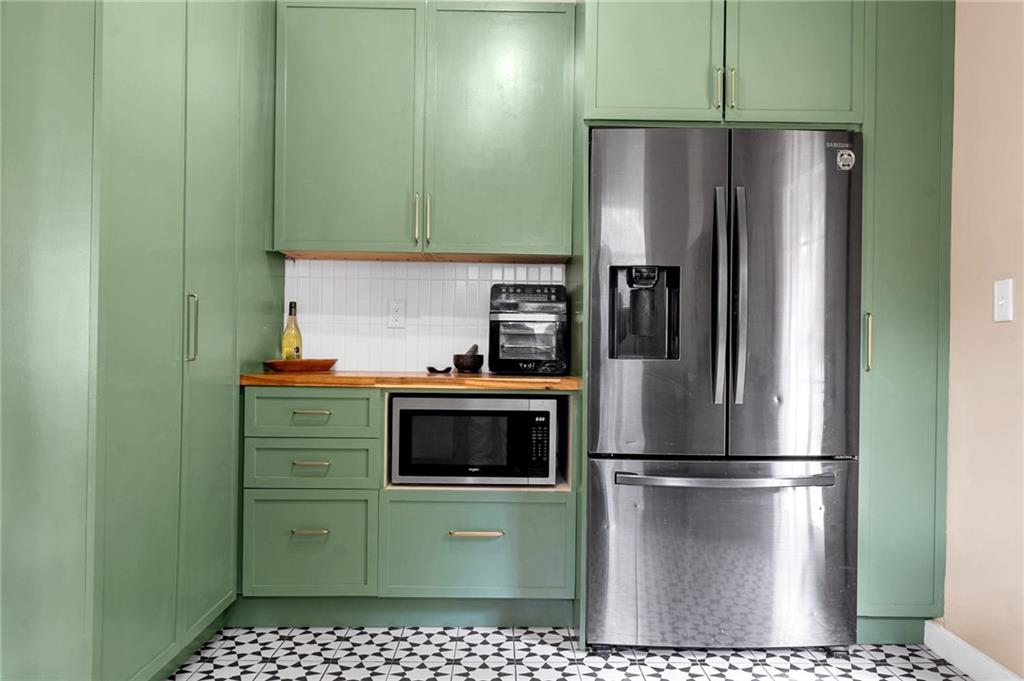 1608 Carroll Drive Northwest Atlanta, GA 30318 - Photo 16 of 43 a kitchen with a refrigerator and a stove top oven