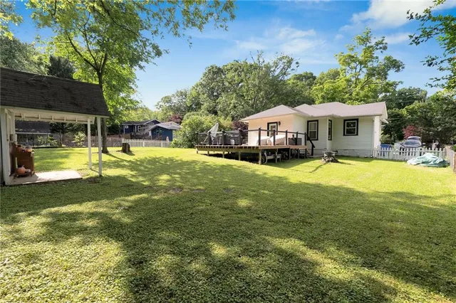 a front view of a house with a garden and sitting area