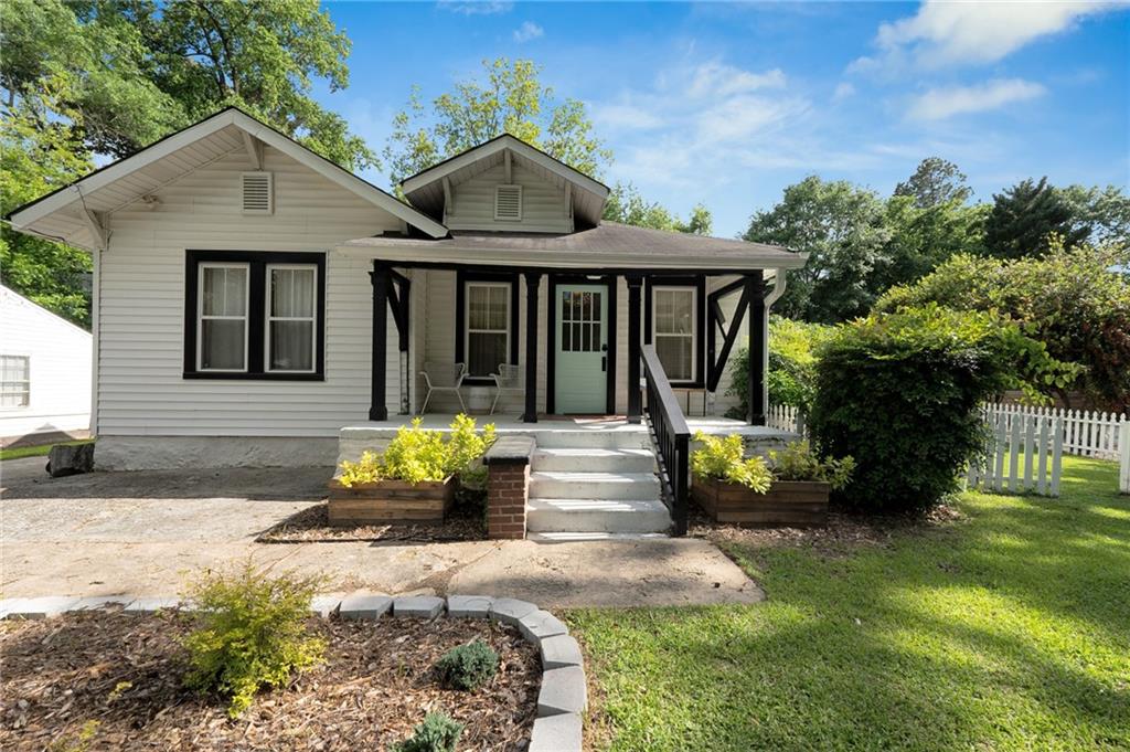 1608 Carroll Drive Northwest Atlanta, GA 30318 - Photo 36 of 43 a front view of a house with a garden and sitting area