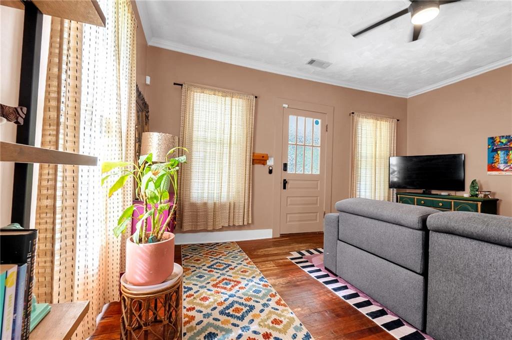 1608 Carroll Drive Northwest Atlanta, GA 30318 - Photo 6 of 43 a living room with furniture a flat screen tv and a large window