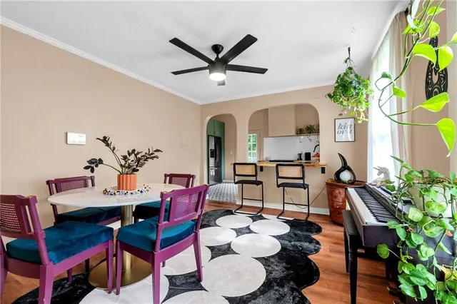 a living room with furniture flowers and a chandelier