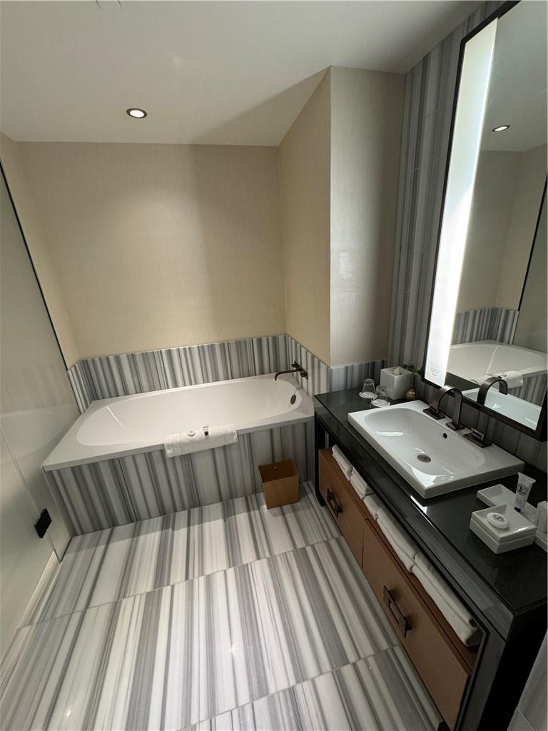 246 Spring Street, Unit 1502 Manhattan, NY 10013 - Photo 11 of 16 Bathroom with tile patterned floors, a bathing tub, and vanity