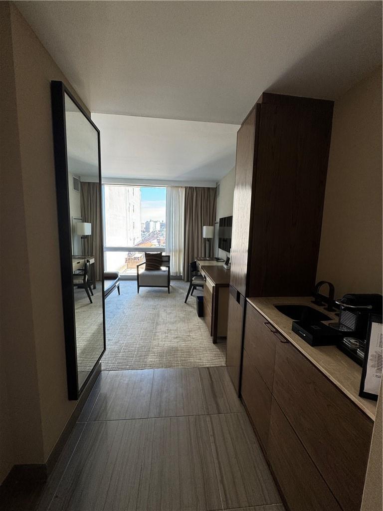 246 Spring Street, Unit 1502 Manhattan, NY 10013 - Photo 7 of 16 Corridor featuring sink and expansive windows