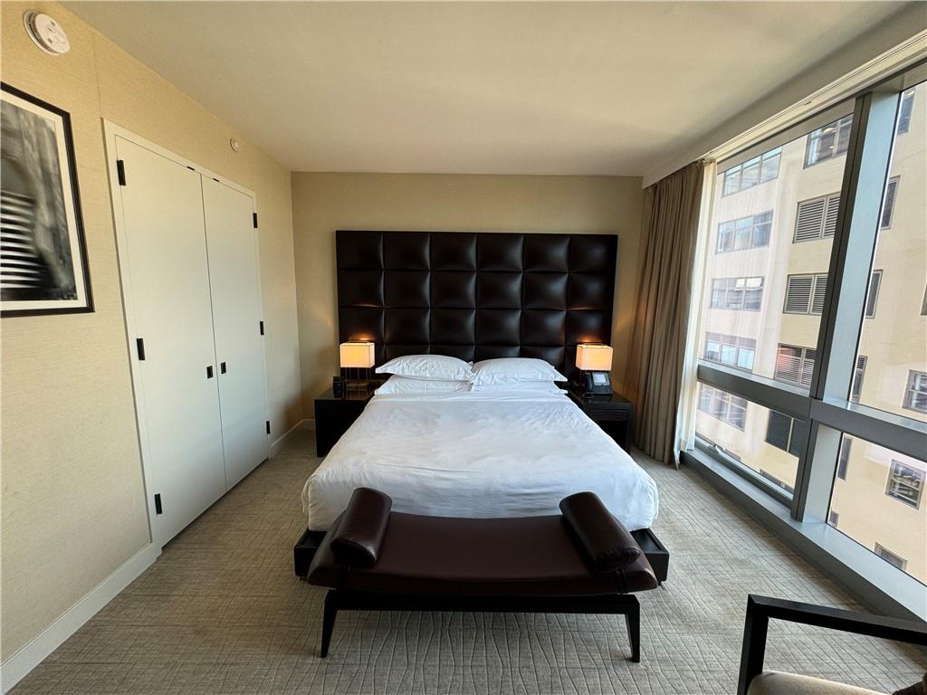 246 Spring Street, Unit 1502 Manhattan, NY 10013 - Photo 8 of 16 Carpeted bedroom with multiple windows