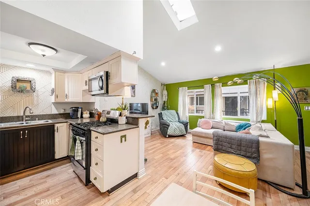 a kitchen with stainless steel appliances granite countertop a stove and cabinets