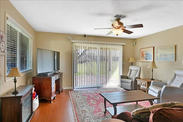 a living room with furniture and a floor to ceiling window