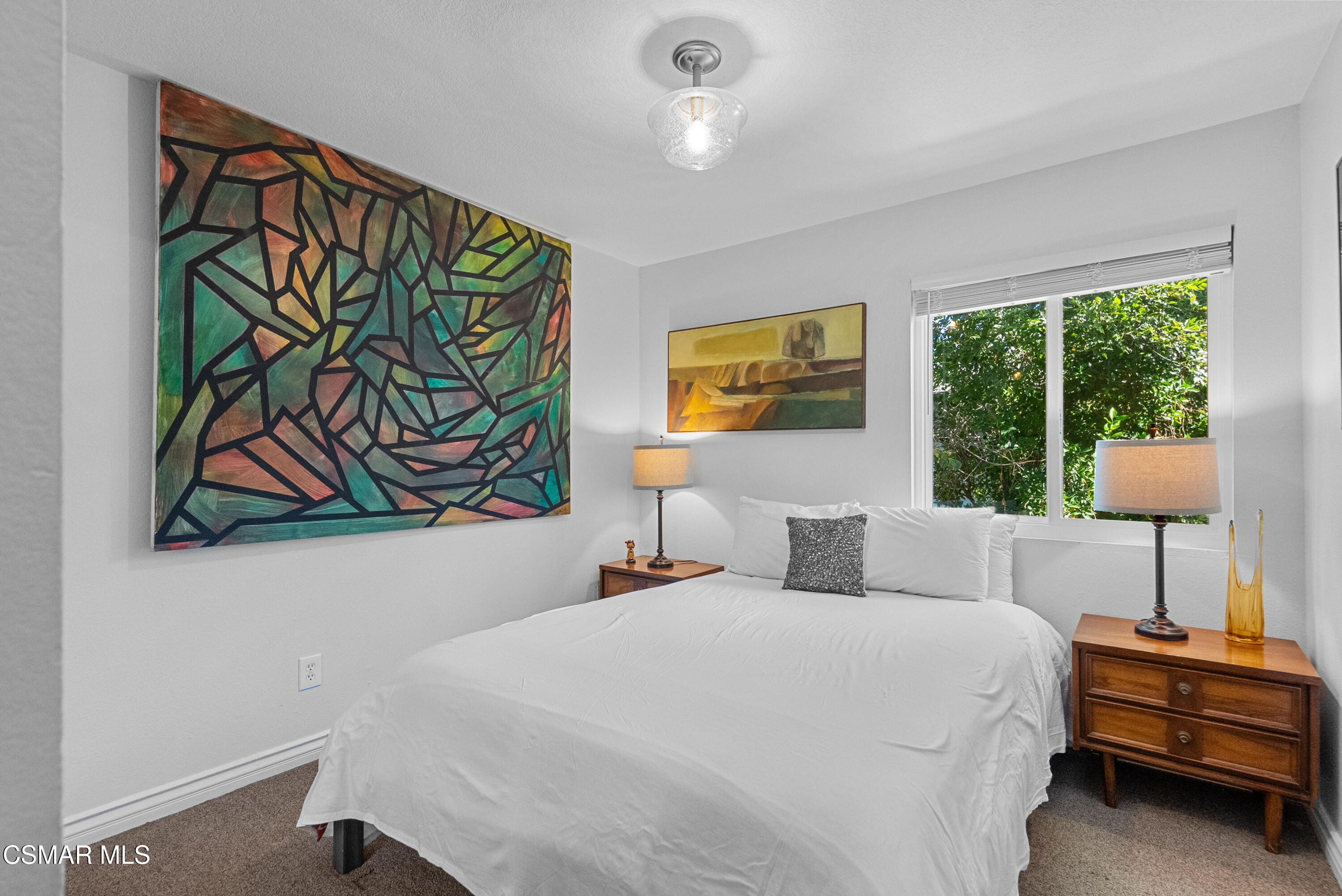 30535 Canwood Street, Unit R58 Agoura Hills, CA 91301 - Photo 13 of 23 a bedroom with a bed and a painting on the wall