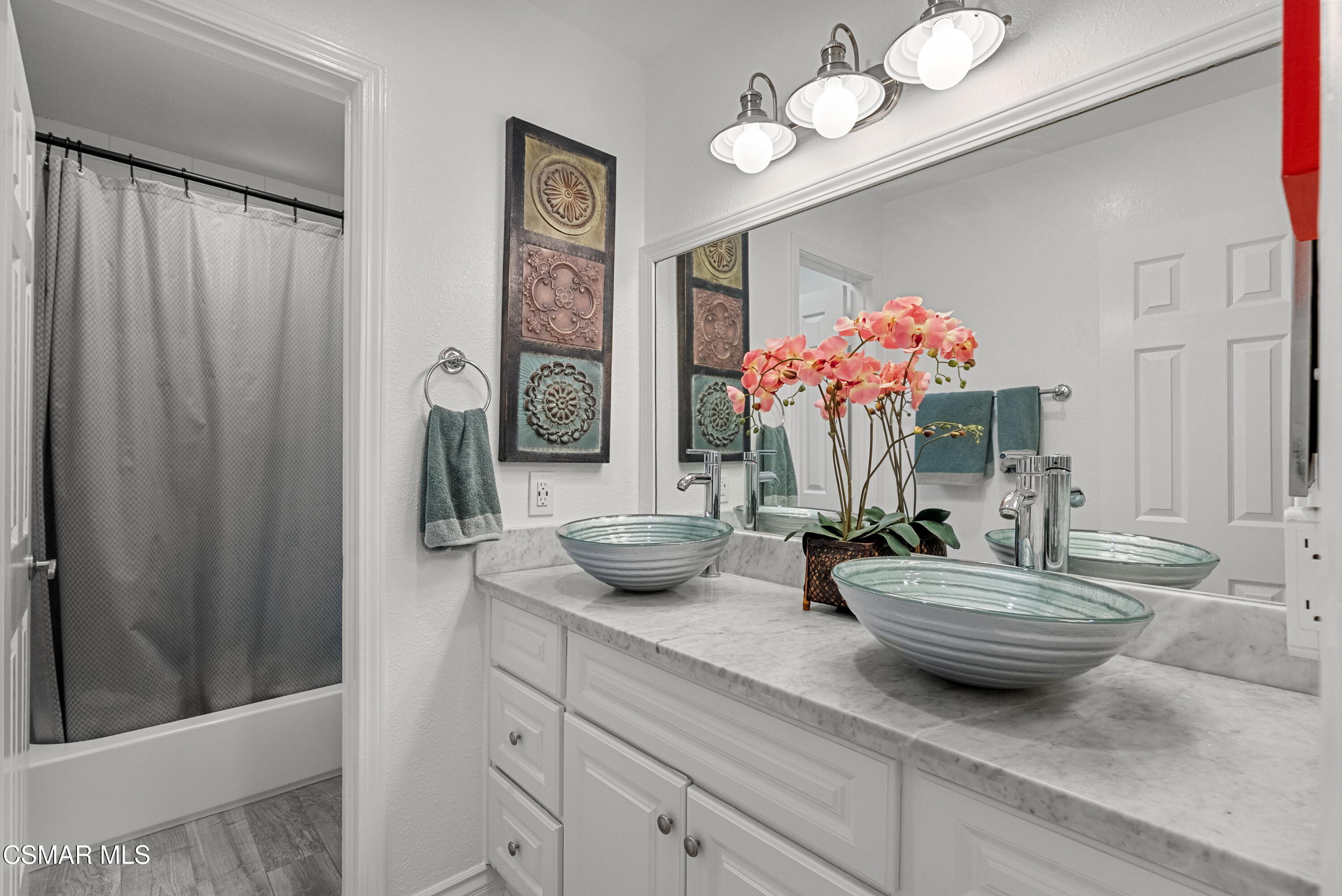 30535 Canwood Street, Unit R58 Agoura Hills, CA 91301 - Photo 14 of 23 a bathroom with a sink mirror and vanity