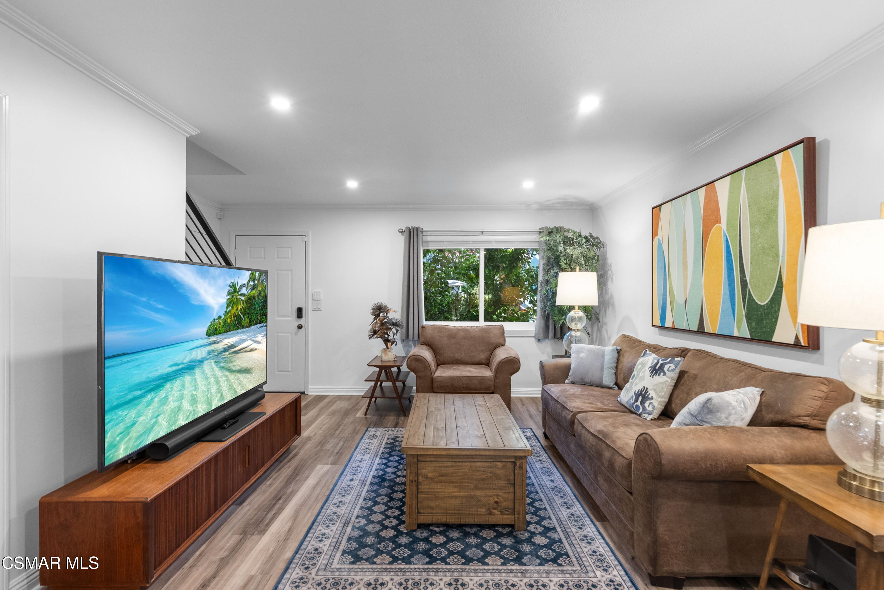 30535 Canwood Street, Unit R58 Agoura Hills, CA 91301 - Photo 3 of 23 a living room with furniture flat screen tv and a large window