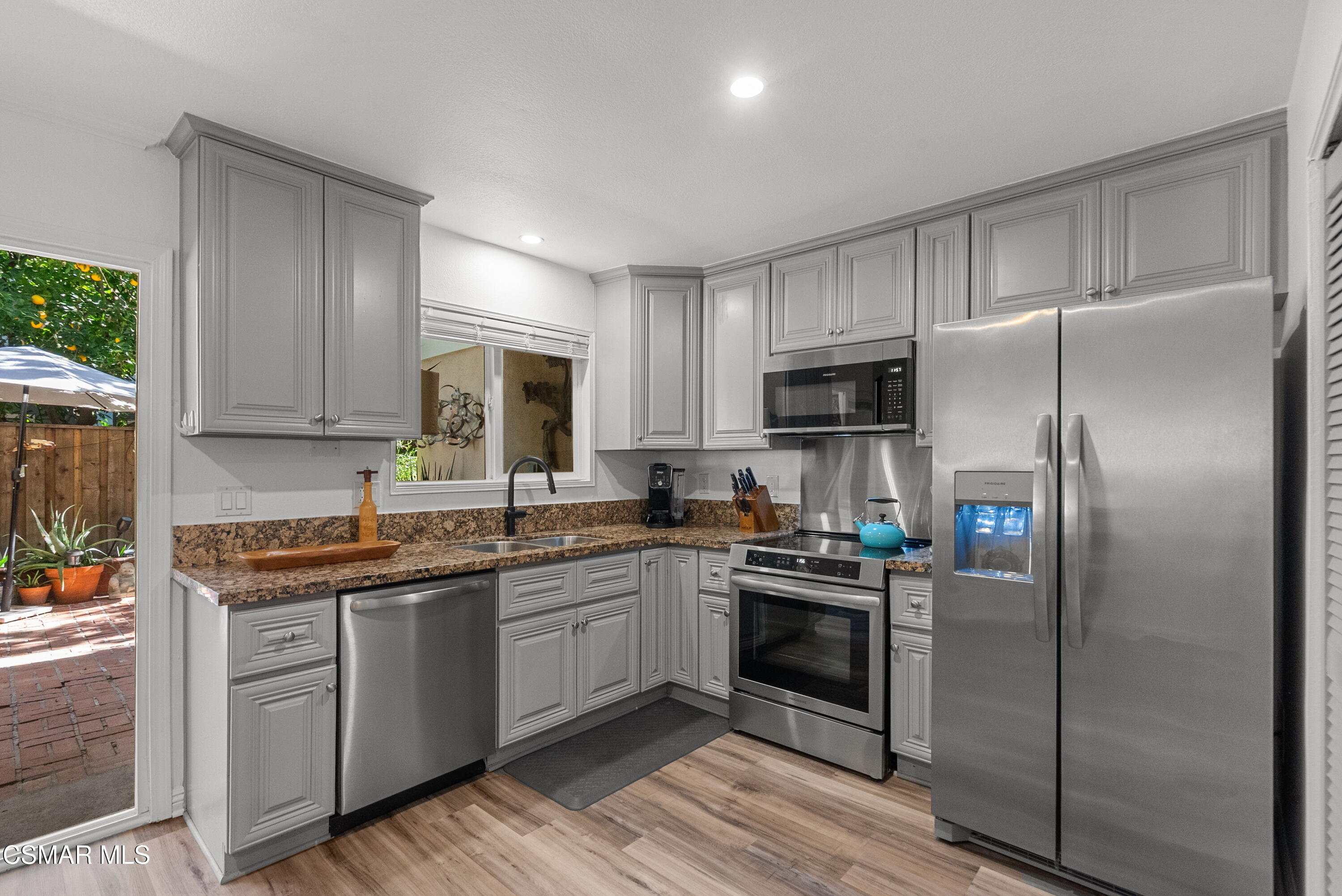 30535 Canwood Street, Unit R58 Agoura Hills, CA 91301 - Photo 5 of 23 a kitchen with a sink stainless steel appliances and cabinets