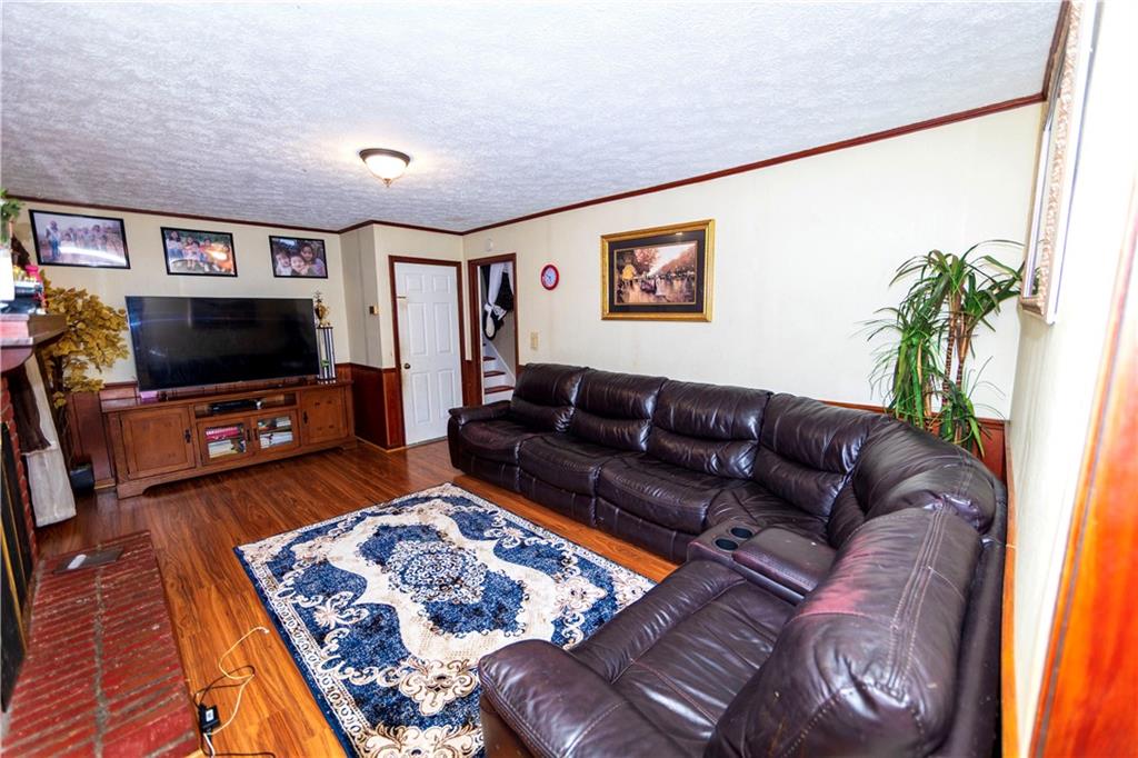 775 Shannon Way Lawrenceville, GA 30044 - Photo 15 of 24 a living room with furniture and a flat screen tv