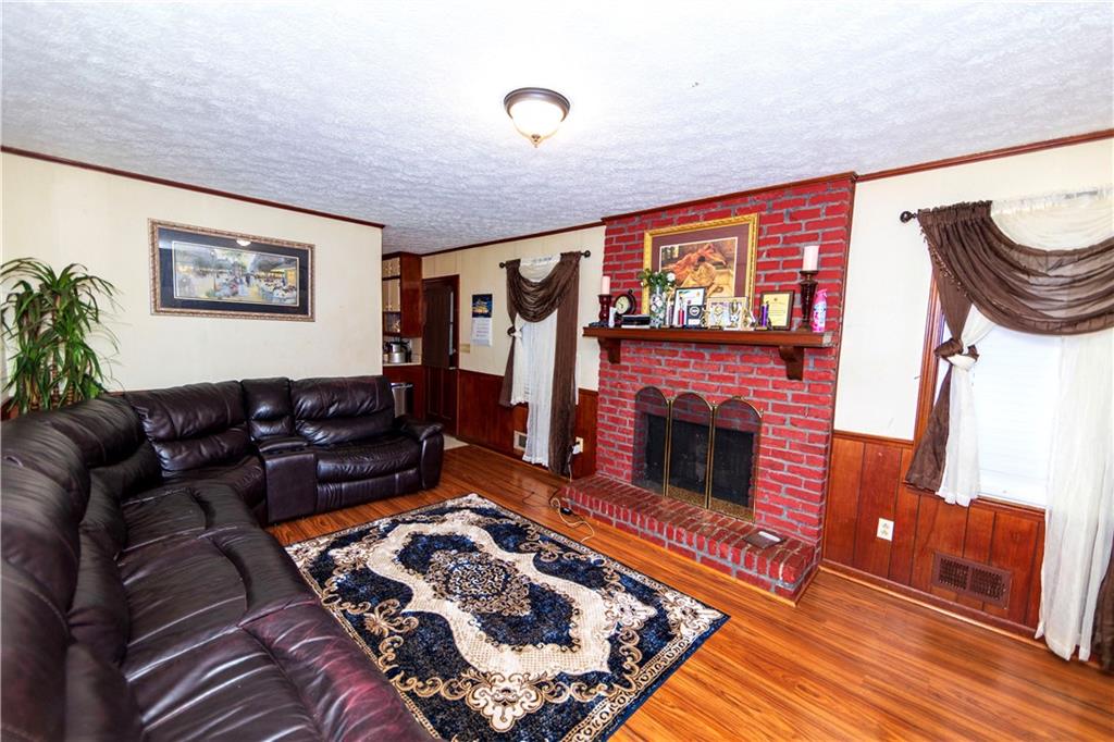 775 Shannon Way Lawrenceville, GA 30044 - Photo 16 of 24 a living room with furniture and a fireplace