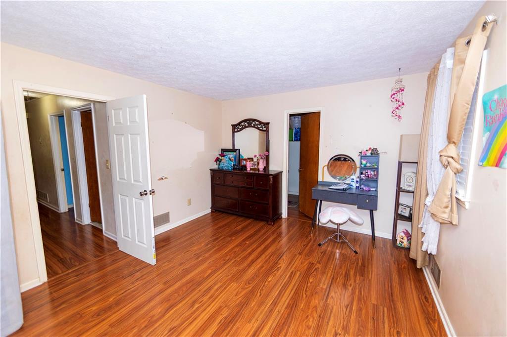 775 Shannon Way Lawrenceville, GA 30044 - Photo 18 of 24 a living room with furniture and a wooden floor