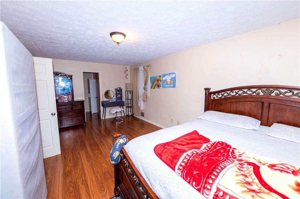 775 Shannon Way Lawrenceville, GA 30044 - Photo 20 of 24 a bedroom with a bed and a table