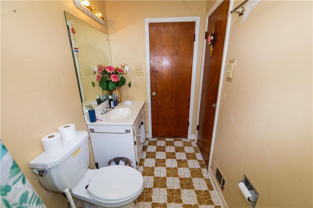 775 Shannon Way Lawrenceville, GA 30044 - Photo 21 of 24 a white toilet sitting next to a sink and a mirror