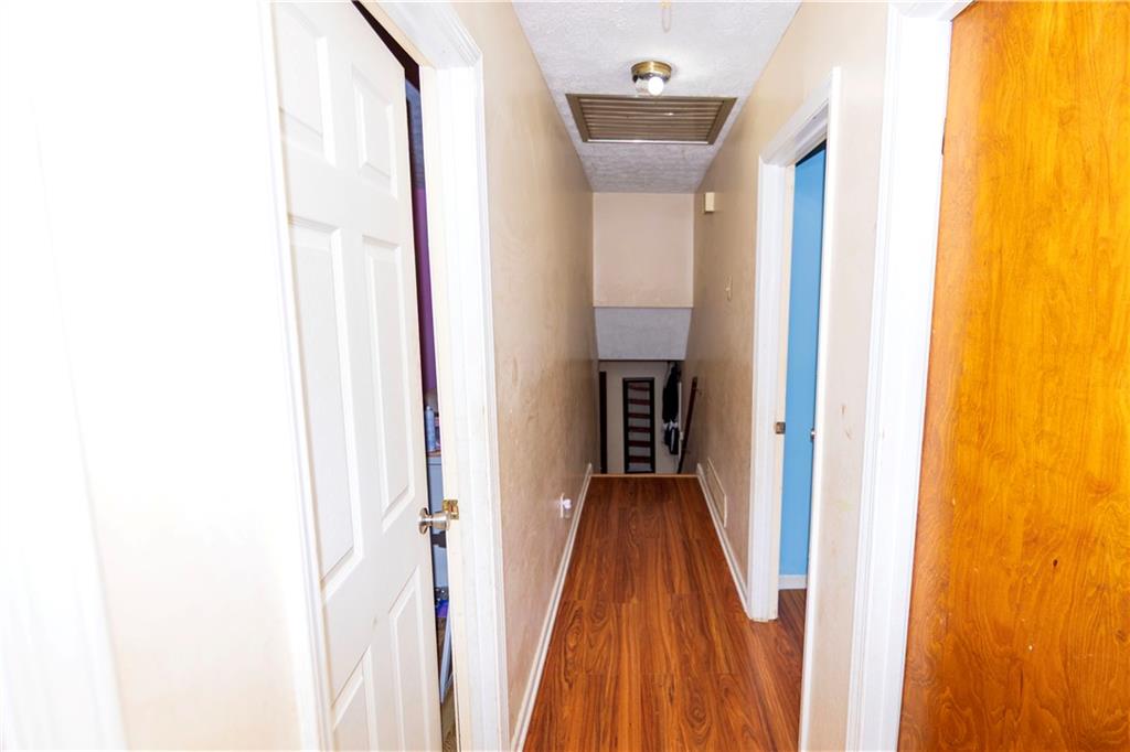 775 Shannon Way Lawrenceville, GA 30044 - Photo 22 of 24 a view of a hallway with wooden floor