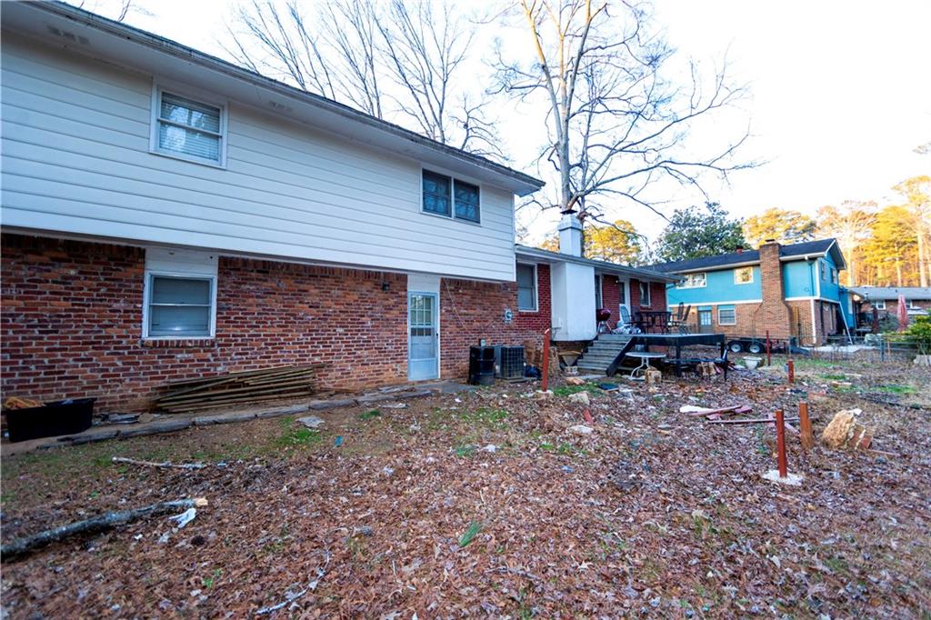 775 Shannon Way Lawrenceville, GA 30044 - Photo 5 of 24 a view of a house with a yard and a tree