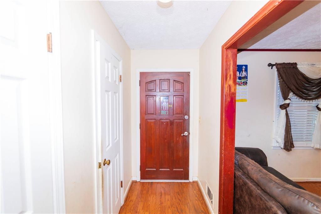 775 Shannon Way Lawrenceville, GA 30044 - Photo 7 of 24 a hallway with sliding door and stairs